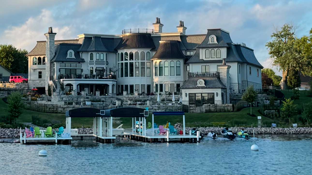 Gatsby custom home by Kingfogl, lakefront rear elevation with boat lifts and docks