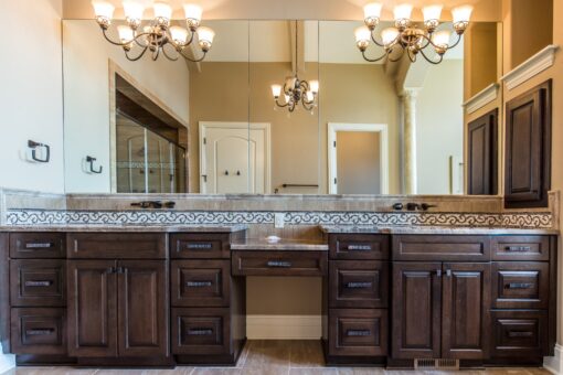 Presidio primary bath dark vanity with chandeliers