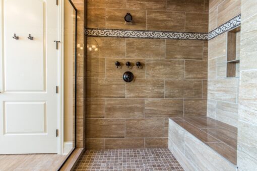 Presidio walk-in shower with stone tile and bench
