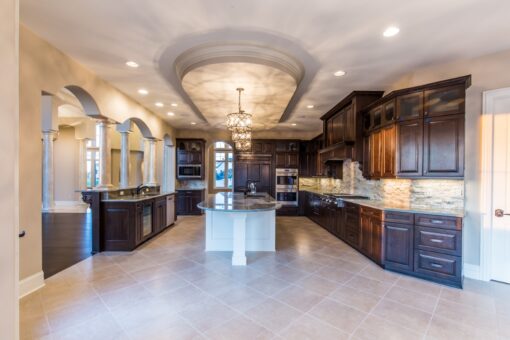 Presidio kitchen with curved island and dark wood cabinetry