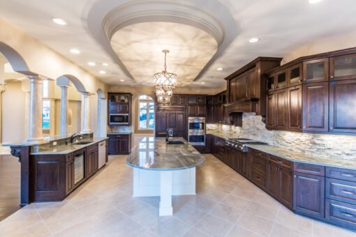 Presidio kitchen with curved white island and coffered ceiling