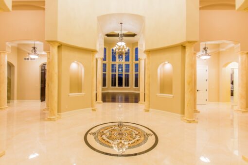 Presidio foyer with marble medallion and lit wall niches
