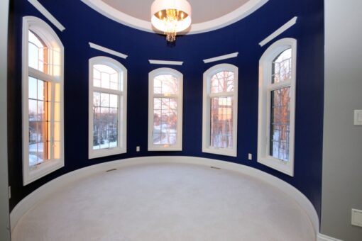 Haven bedroom with arched windows and navy walls