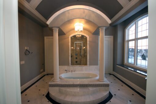 Haven primary bath tub framed by columns