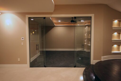 Haven lower-level exercise room with frameless glass doors