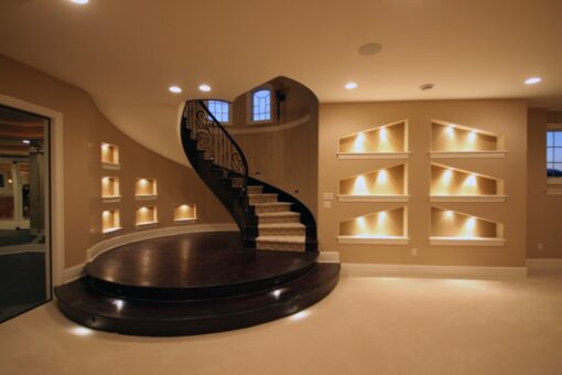 Haven lower-level spiral staircase and lit niches