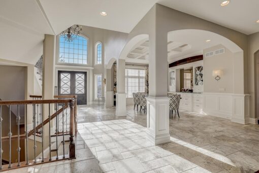 Wildwood foyer with arched double doors and columns
