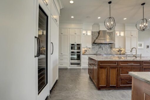 Wildwood white kitchen with wood island and lantern pendants