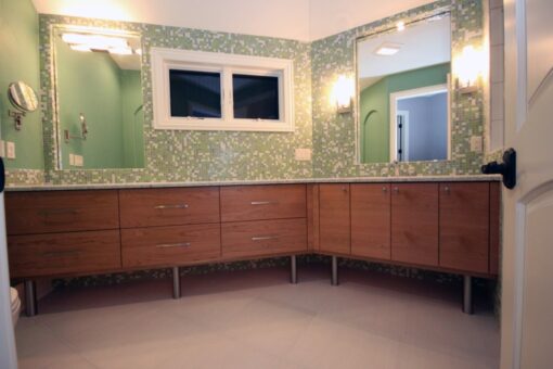 Haven bathroom with green mosaic tile and wood vanity