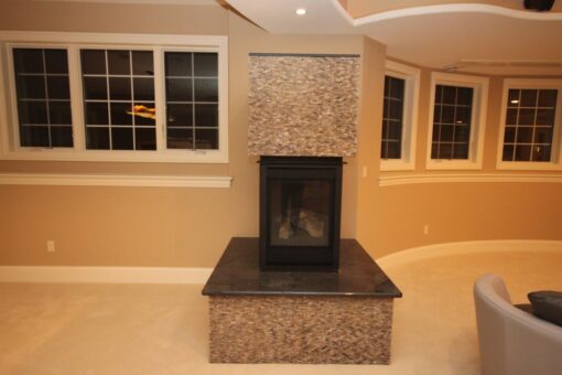 Haven lower-level fireplace with mosaic surround