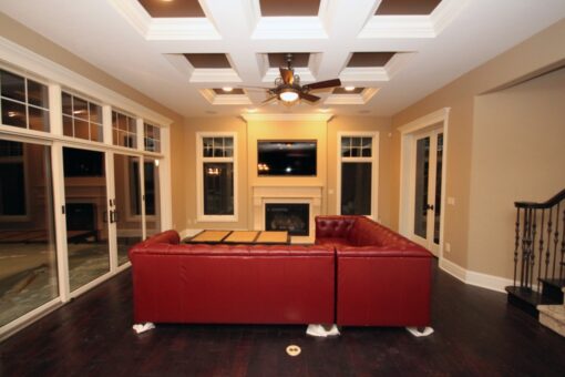 Haven hearth room with red sectional and coffered ceiling