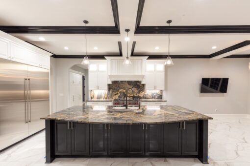 Woodland kitchen with dark island and coffered ceiling