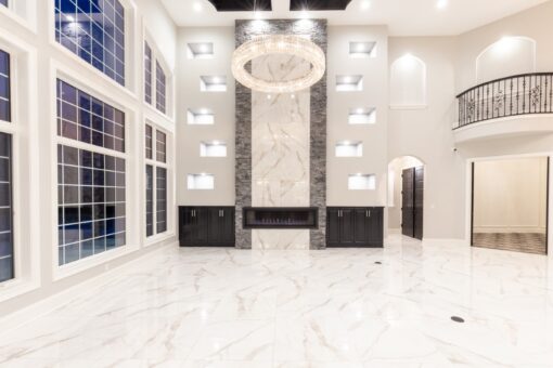Woodland two-story great room with fireplace wall and lit niches