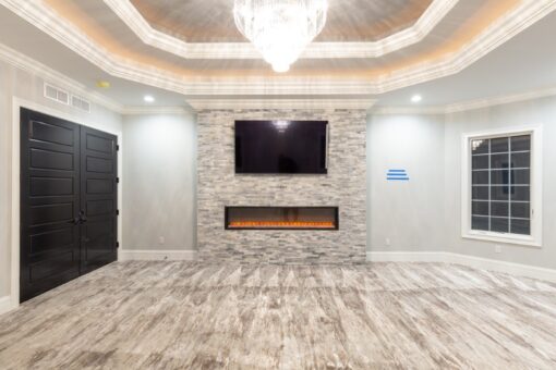 Woodland bedroom with stacked stone linear fireplace
