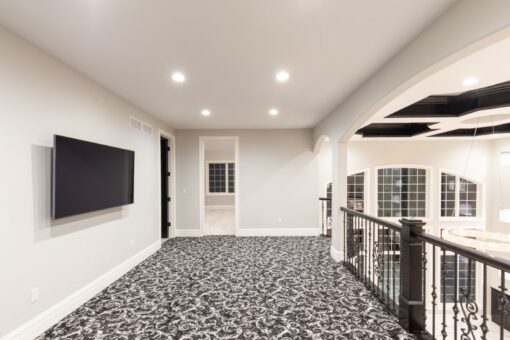 Woodland loft with media wall and iron railing