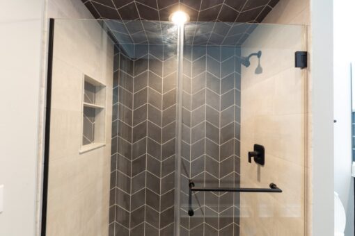 Woodland walk-in shower with black chevron tile