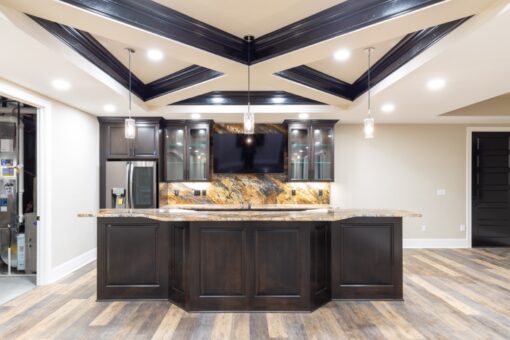 Woodland lower-level bar with dark cabinetry