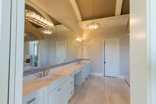 Callista primary bath long double vanity with chandeliers