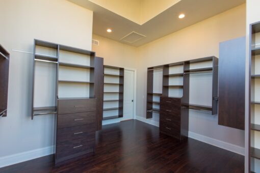 Callista walk-in closet with dark wood built-ins