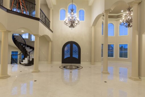 Callista two-story foyer with arched doors and chandelier