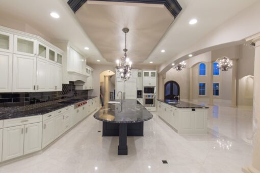 Callista kitchen with oval island and white cabinetry
