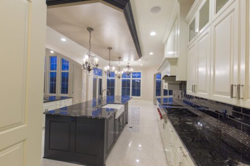 Callista kitchen with dark island and chandeliers