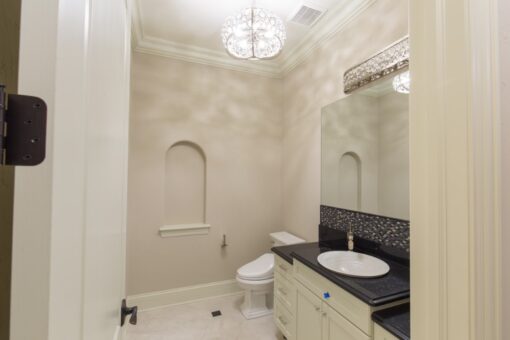 Callista powder room with arched niche and black granite