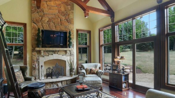Buckingham hearth room with stone fireplace and windows