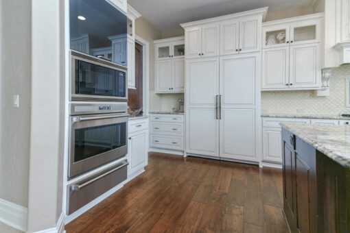 Bradon kitchen with white cabinetry and double wall ovens