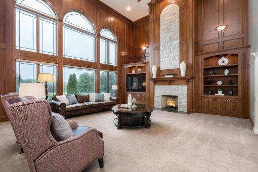 Brookridge two-story great room with wood paneling and window wall