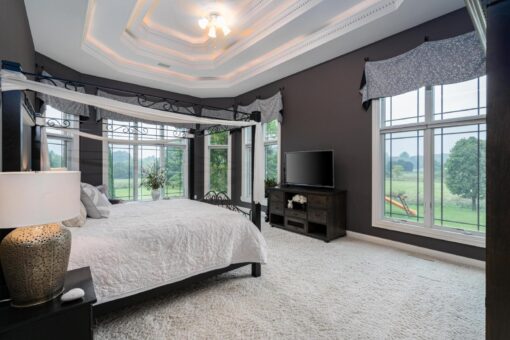 Brookridge bedroom with tray ceiling and bay window