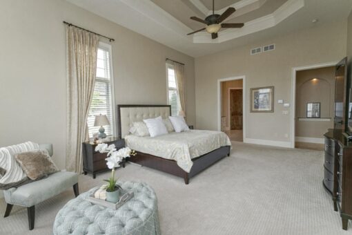 Bradon bedroom with tray ceiling and sitting area