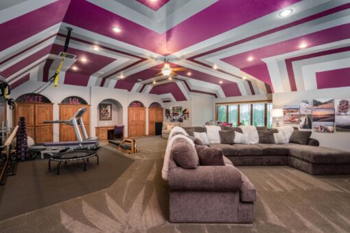 Brookridge bonus room with beamed ceiling and sectional