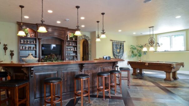 Buckingham lower-level bar with dark wood and pendant lights