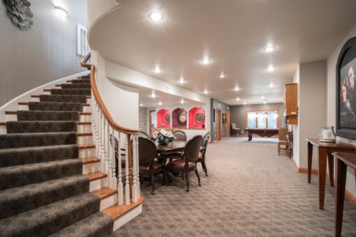 Brookridge lower level with curved staircase and dining area