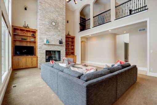 Ridgeview great room stone fireplace with balcony above