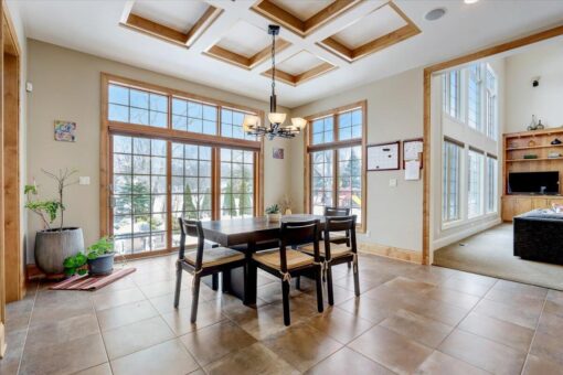 Ridgeview breakfast area with window wall and coffered ceiling