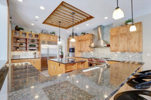 Ridgeview kitchen with granite island and wood ceiling