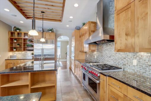 Ridgeview kitchen with maple cabinetry and range hood