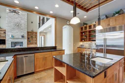 Ridgeview kitchen island with black granite and stainless appliances