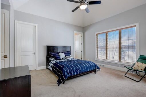 Ridgeview bedroom with dark wood bed and windows