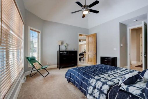 Ridgeview bedroom with ceiling fan and windows