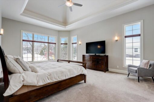 Ridgeview primary bedroom with tray ceiling and window wall