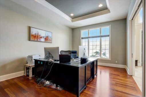 Ridgeview home office with tray ceiling and hardwood floors