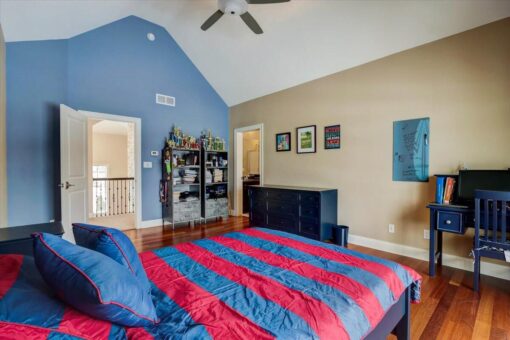 Ridgeview bedroom with navy accent wall and hardwood floors