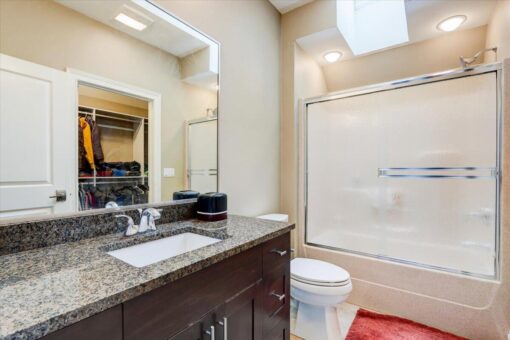 Ridgeview bathroom with granite vanity and skylight