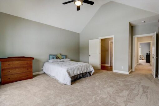Ridgeview bedroom with vaulted ceiling and ceiling fan