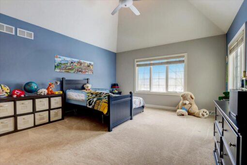 Ridgeview bedroom with blue accent wall and vaulted ceiling