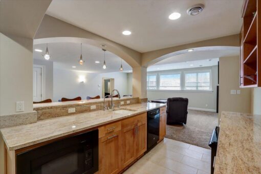 Ridgeview lower-level kitchen with granite counters and arched openings