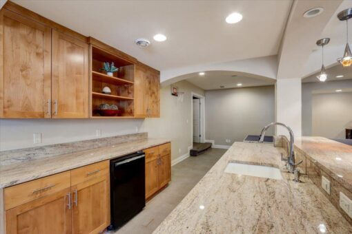Ridgeview lower-level kitchen with maple cabinetry and granite